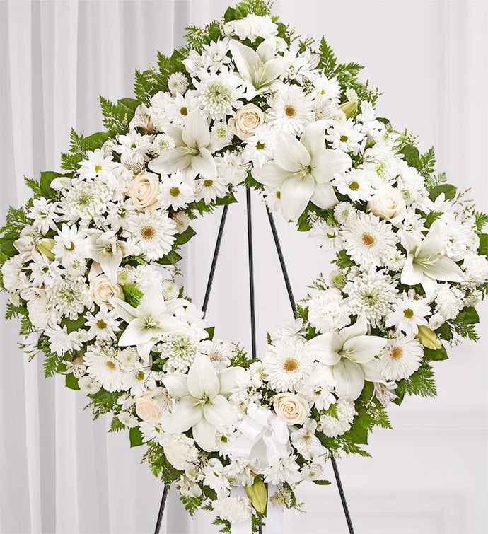 about elegant white wreath on ruscus wrapped easel from Walter Knoll  Florist, St Louis, MO